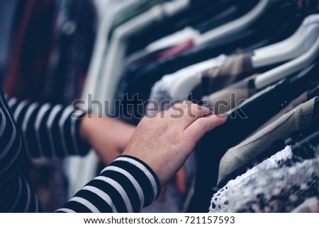 Сток-фото: Woman Browsing Through Clothing At Second Hand Street Market