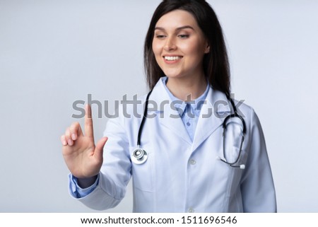 Foto stock: Brunette Doctor Pressing Touchscreen