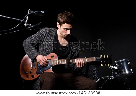 Foto stock: Man Playing Guitar During Concert