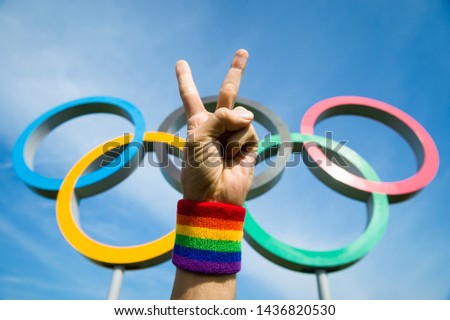 Stok fotoğraf: Hands With Gay Pride Rainbow Wristbands Make Peace