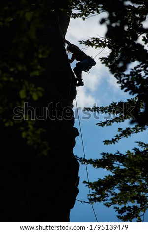 Foto stock: Silhouette Of Rock Climber Against Vertical Wall Concept Of Achi
