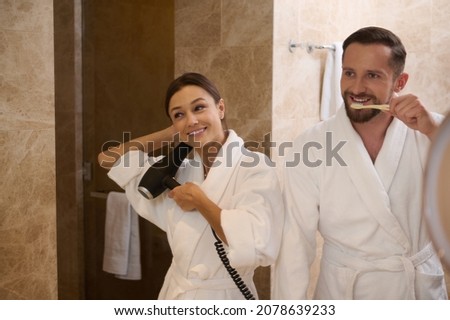 Stok fotoğraf: Woman Drying Hair Next To Partner