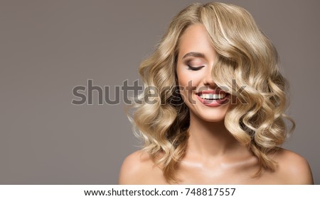 Сток-фото: Girl With Long Blond Curly Hair On The Background Of A Christmas Tree In The Studio