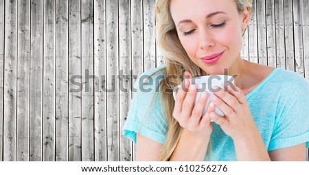 Stock photo: Close Up Of Woman Looking Down At White Cup Against Grey Wood Panel