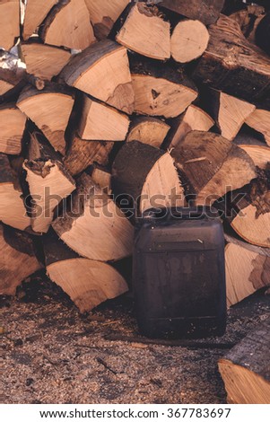 Zdjęcia stock: Firewood Pile And Plastic Oil Canister