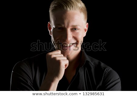 Stok fotoğraf: Low Key Portrait Of Smiling Charming Man Looking Straight