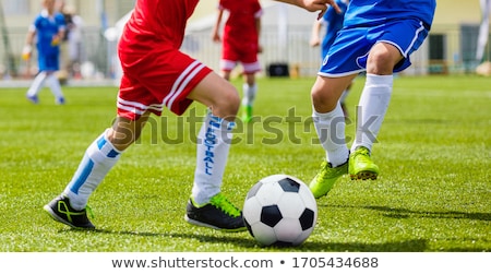 Soccer Player Running And Kicking Ball On A Game Junior Level Stockfoto © matimix