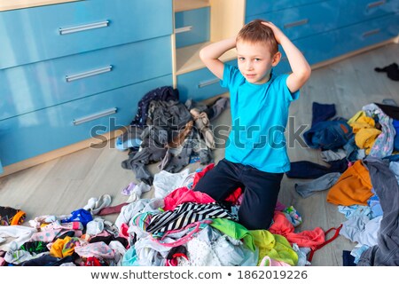 Stock foto: Small Boy Desperate With The Mess In His Clothes