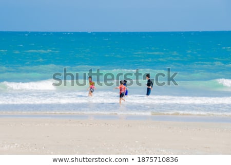 Stock foto: Boys Having Fun In The Beautiful Clear Sea