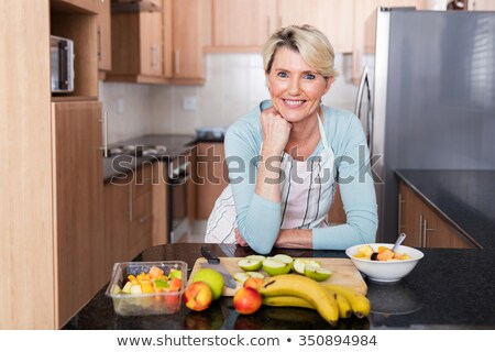 Stock fotó: Mature Woman Preparing To Clean Table