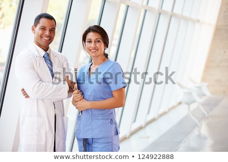 Stock fotó: Doctor And Nurse Discussing Charts