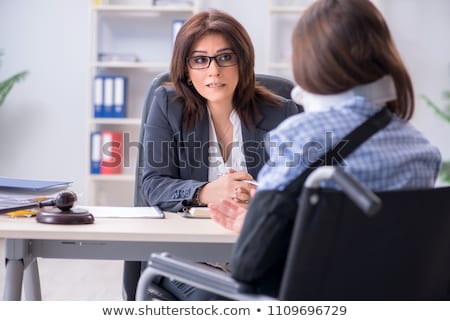 [[stock_photo]]: Injured Employee Visiting Lawyer For Advice On Insurance