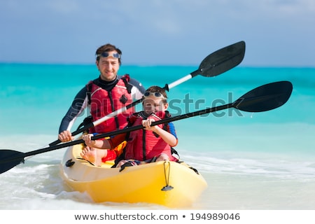 Foto stock: Father And Son Kayaking At Tropical Ocean