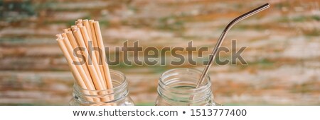 Stok fotoğraf: Steel Drinking Vs Disposable Straws On Painted Wooden Background Zero Waste Concept