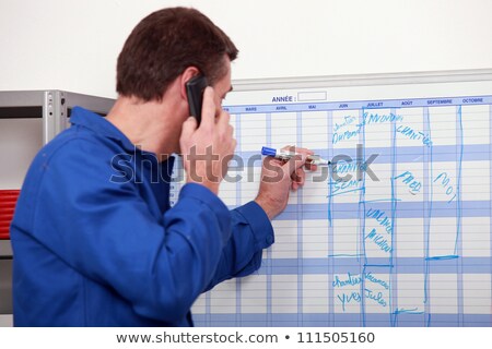 Zdjęcia stock: Manual Workers Writing On A Calendar