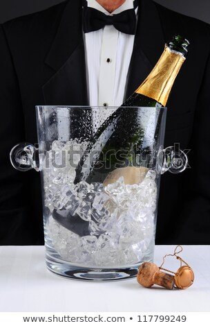 Foto stock: Waiter Standing Behind A Champagne Bucket