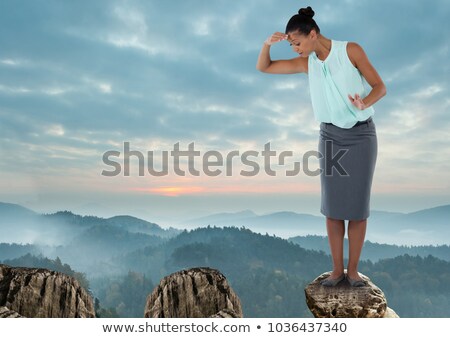 Foto stock: Businesswoman On Rock Mountain With A Tree