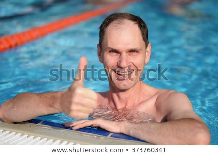ストックフォト: Male Giving Thumb Up By Outdoor Swimming Pool