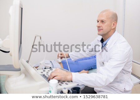 Сток-фото: Confident Professional Looking At Screen While Making Ultrasonic Examination