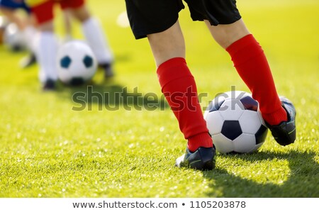 Stock photo: Closeup Of Boys Kicking Soccer Ball Running Soccer Football Players Junior Footballers On Duel