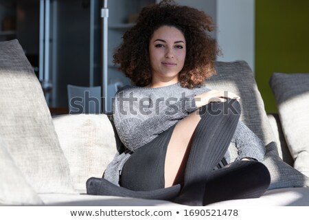 Stock fotó: Happy Woman Sitting In The Sun On Indoor Lounge