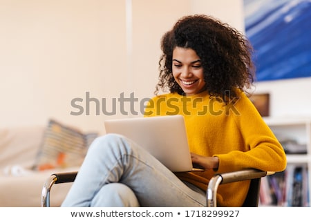 Stock foto: African Woman Indoors At Home Using Laptop Computer