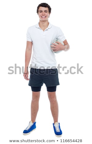 Сток-фото: Energetic Football Player Holding Ball Tightly