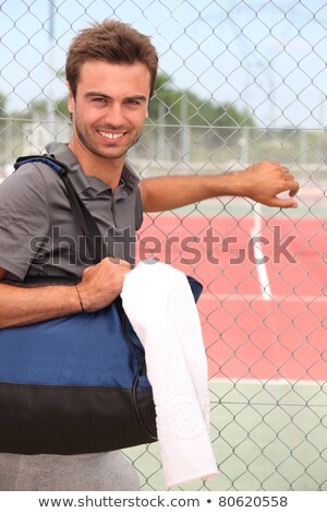 ストックフォト: Smiling Male Tennis Player With Kitbag Outside Court