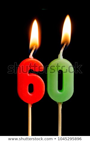 Stok fotoğraf: Birthday Cake With Burning Candle Number 60