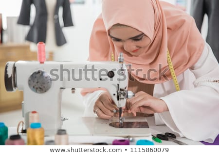 Сток-фото: Female Designer Using Sewing Machine In Workshop