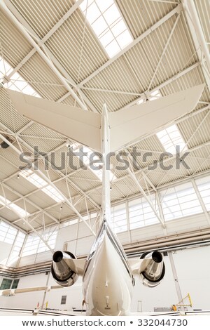 Сток-фото: Airplane Tail Inside Brightly Lit Hangar