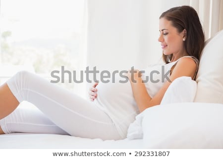 Stok fotoğraf: Pregnant Woman Sitting Relax On Bed