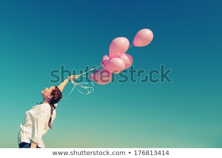 Stok fotoğraf: Girl Holding Pink Balloon With Smiling Face