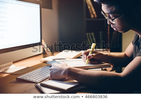Foto d'archivio: Handsome Asian Young Man Using Computer In Dark Room