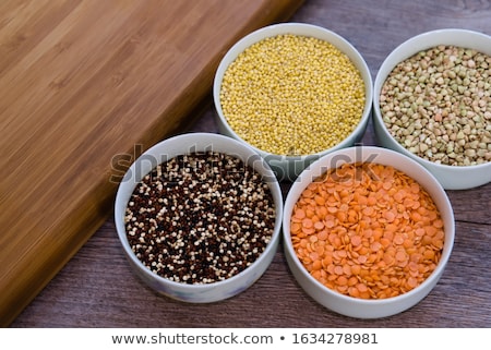 Foto stock: Quinoa In Wooden Bowl On Brown Bamboo Board Closeup