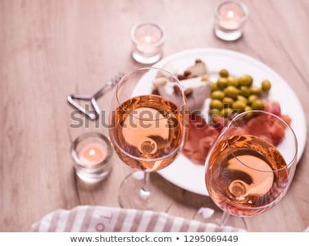 Foto stock: Two Glasses Of Rose Wine And Board With Fruits Bread And Cheese