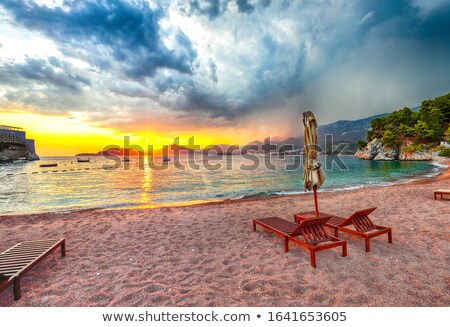 Zdjęcia stock: Picturesque Beach Umbrella And Deck Chairs At Sunset