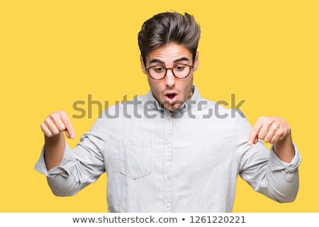 Foto d'archivio: Portrait Of Surprised Casual Man Looking Down With Mouth Open