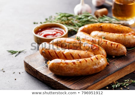 Foto stock: Fried Sausage In A Frying Pan With Herbs And Spices