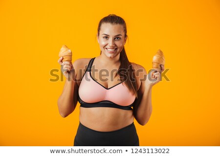 Сток-фото: Image Of Happy Big Woman In Tracksuit Holding Two Croissants In