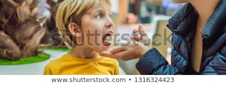 Foto stock: Boy At The Airport - Young Boy Eating Food While Waiting For His