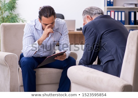 Stockfoto: Old Man Visiting Young Male Doctor