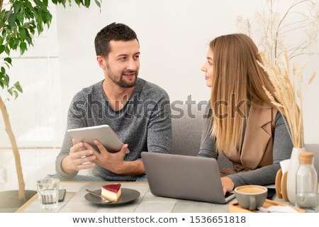 Stockfoto: Confident Businessman With Touchpad Looking At His Colleague During Discussion