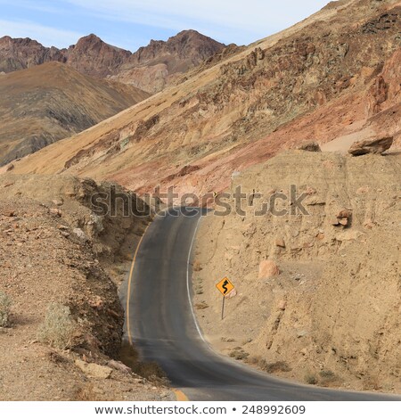 ストックフォト: Scenic Road Artists Drive In Death Valley With Road Sign Dip For