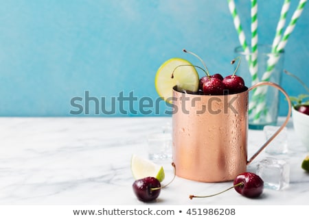 Foto stock: Cold Cherry Moscow Mules Cocktail With Ginger Beer Vodka Lime Marble Background Copy Space