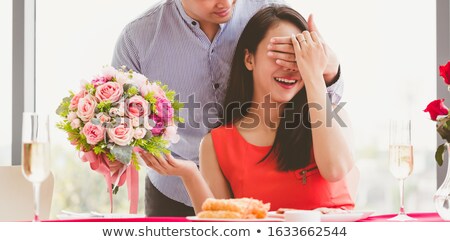 Stock fotó: Woman Holding Flower Bouquet Smiling At Man