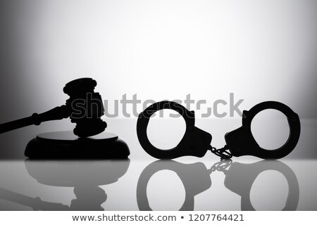 [[stock_photo]]: Handcuff Near Gavel With Sounding Block