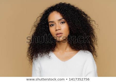 Foto stock: Portrait Of A Pensive Woman With Dark Curly Hair