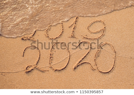 Stock foto: New Year 2020 Is Coming Concept - Inscription 2019 And 2020 A Beach Sand The Wave Is Almost Coverin