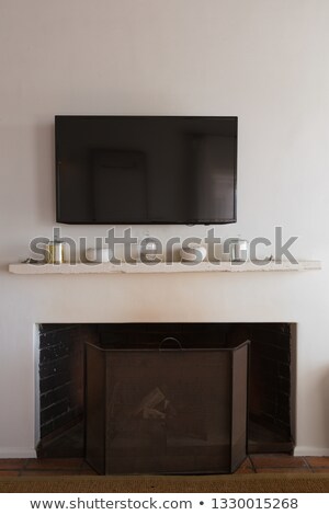 Stock fotó: Front View Of A Wall Television Above Decorative Objects On An Extinct Fireplace At Home